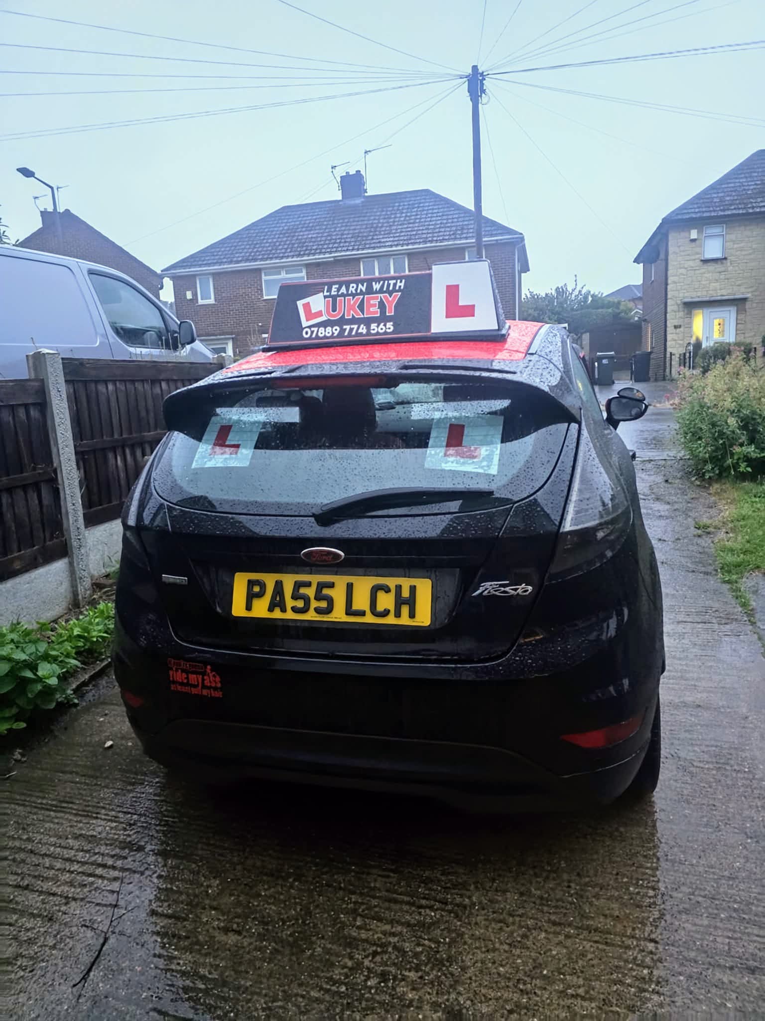 Rear view of the Learn With Lukey manual learner car in the rain